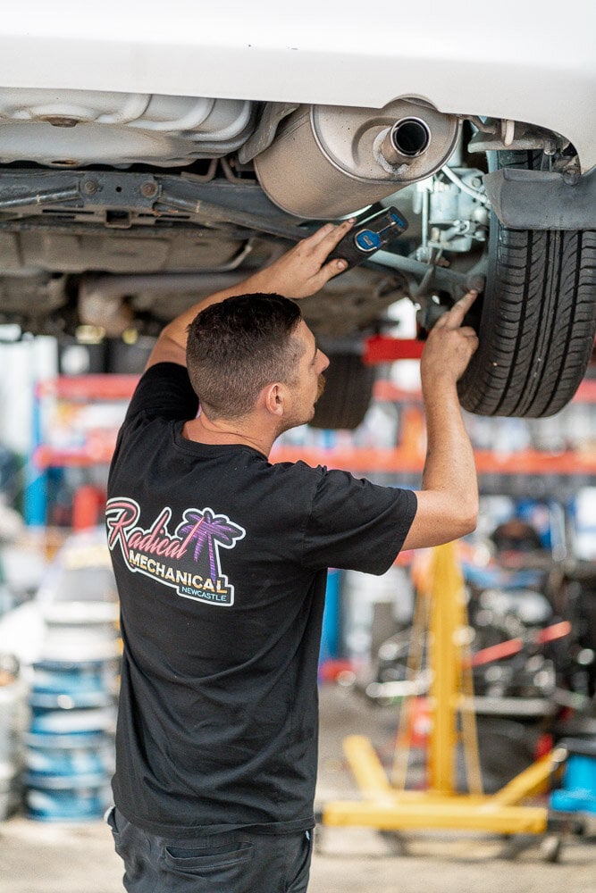How do you find a mechanic in Newcastle who won’t rip you off? » honest mechanic Newcastle A Radical Mechanical mechanic checking under a car on the hoist